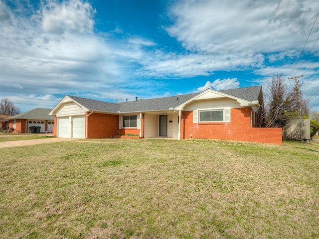 ranch-style house featuring a garage and a front lawn