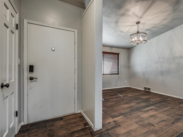 entryway featuring dark hardwood / wood-style floors and a chandelier