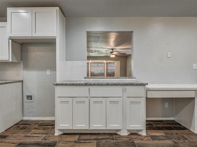 kitchen featuring white cabinetry and dark hardwood / wood-style floors