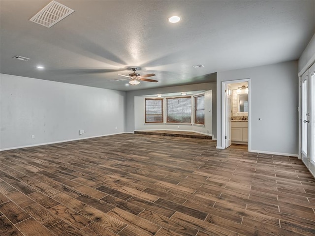 interior space featuring ceiling fan and dark hardwood / wood-style flooring