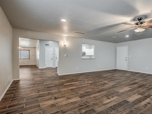 unfurnished room with ceiling fan and dark hardwood / wood-style floors