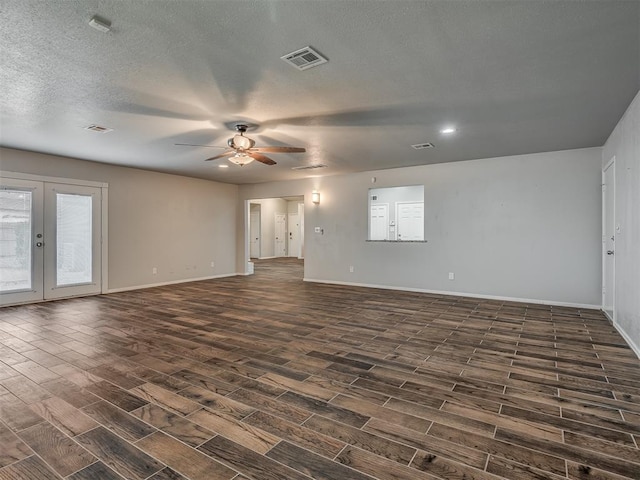 spare room featuring dark hardwood / wood-style floors, ceiling fan, a textured ceiling, and french doors