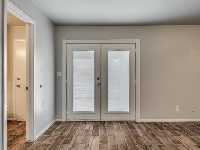 entryway featuring dark hardwood / wood-style flooring and french doors