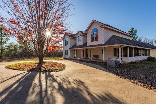 view of side of property with covered porch