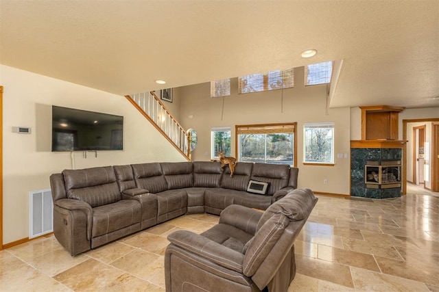 living room with a textured ceiling and a premium fireplace