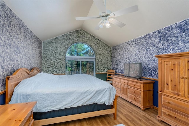 bedroom with ceiling fan, wood-type flooring, and vaulted ceiling