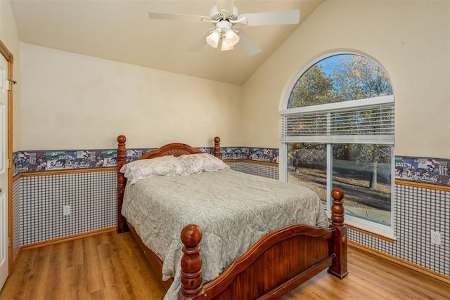 bedroom featuring ceiling fan, wood-type flooring, and vaulted ceiling