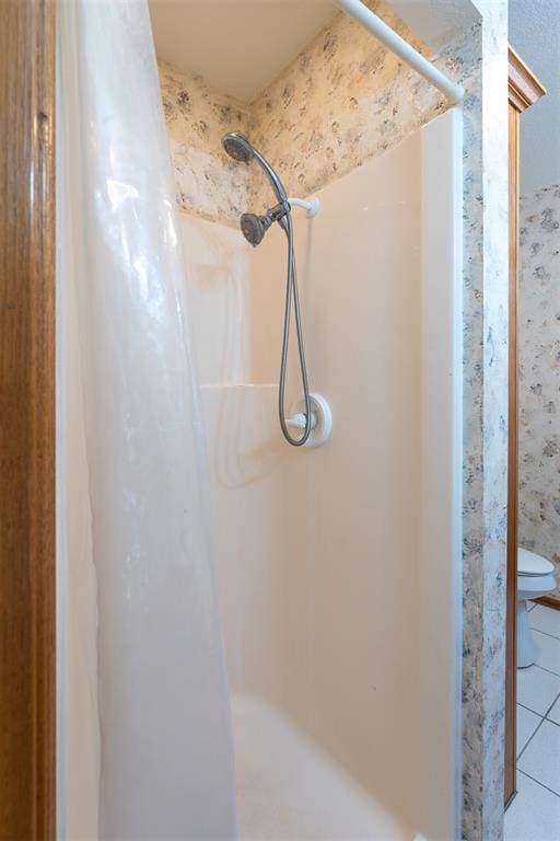 bathroom with tile patterned flooring and curtained shower