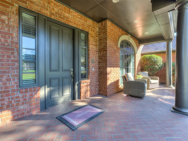 view of exterior entry with covered porch