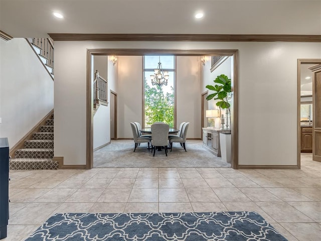 tiled dining area with a notable chandelier and ornamental molding