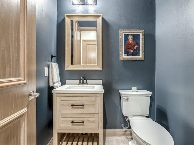 bathroom with hardwood / wood-style flooring, vanity, and toilet