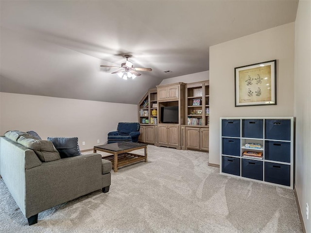 carpeted living room featuring ceiling fan and vaulted ceiling