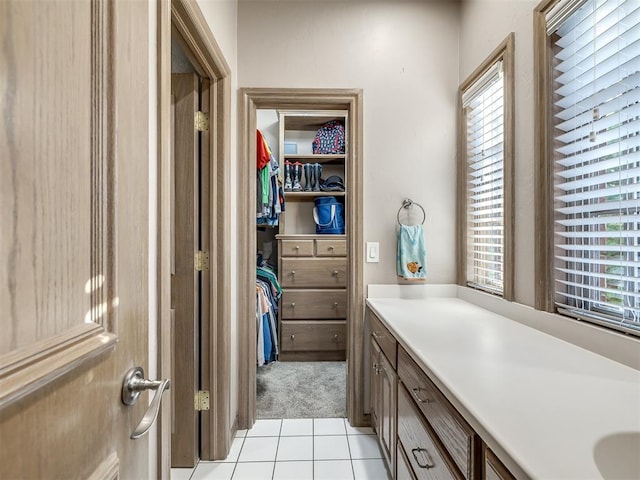 bathroom with tile patterned flooring and vanity