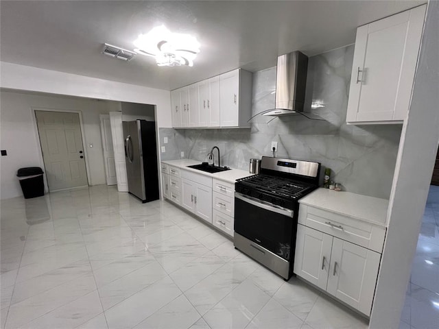 kitchen with white cabinets, sink, wall chimney exhaust hood, and appliances with stainless steel finishes