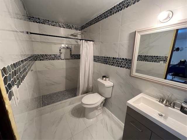 bathroom with a shower with curtain, vanity, toilet, and tile walls