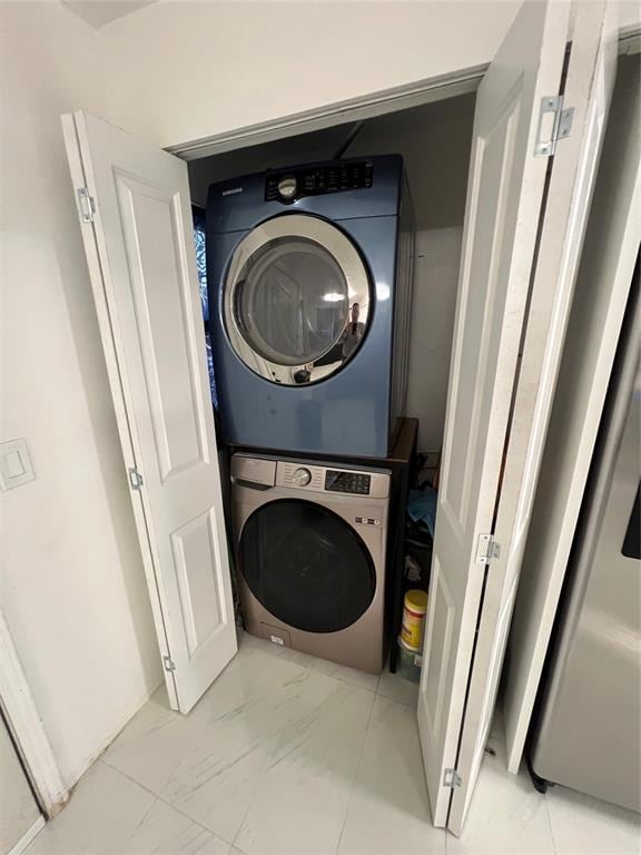 laundry room with stacked washer / drying machine