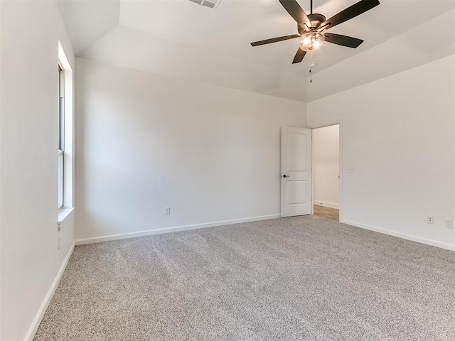 carpeted spare room with vaulted ceiling and ceiling fan