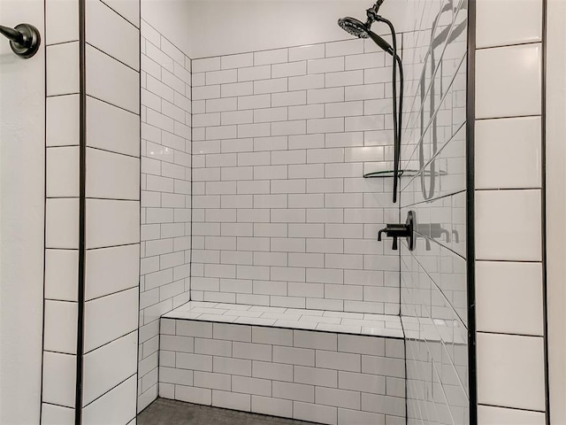 bathroom with tiled shower