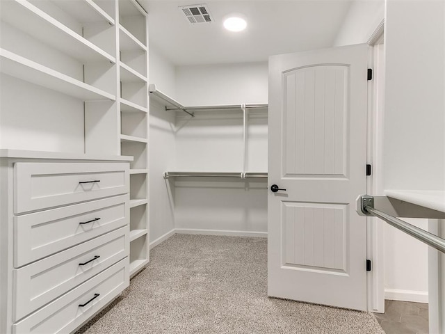 spacious closet featuring light carpet