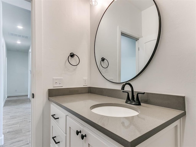 bathroom featuring hardwood / wood-style floors and vanity