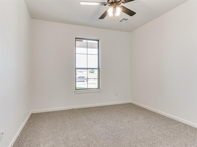 carpeted spare room featuring ceiling fan