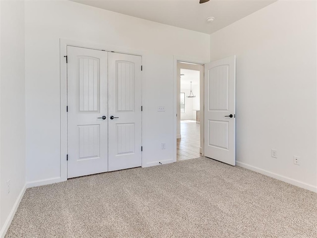 unfurnished bedroom with carpet and a closet