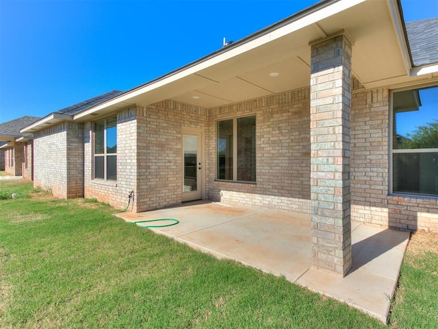 back of property featuring a yard and a patio