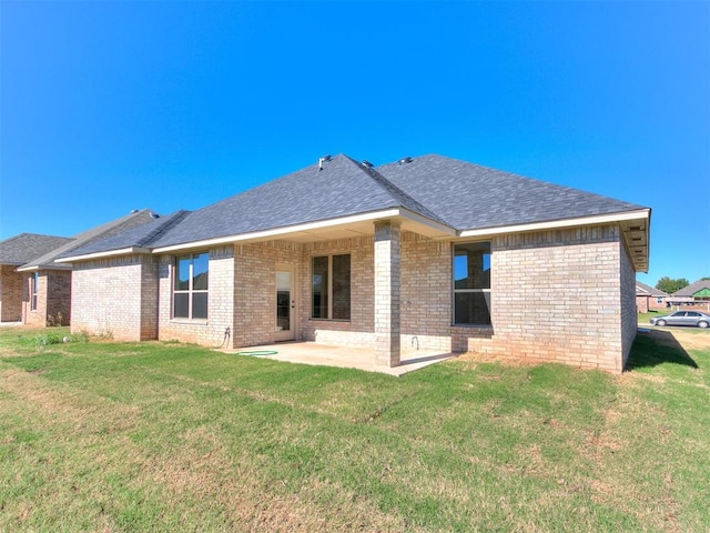 back of house with a lawn and a patio area