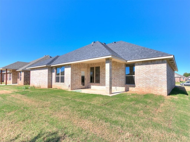 rear view of house featuring a patio and a lawn