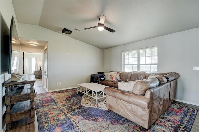 living room featuring hardwood / wood-style floors, vaulted ceiling, and ceiling fan