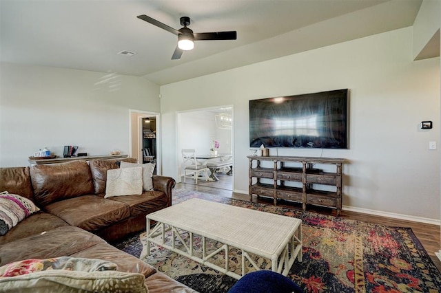 living room featuring ceiling fan, wood-type flooring, and lofted ceiling