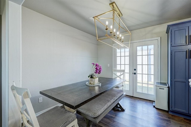 dining room featuring a chandelier, dark hardwood / wood-style flooring, and french doors