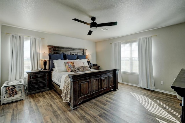 bedroom featuring wood-type flooring, a textured ceiling, and ceiling fan