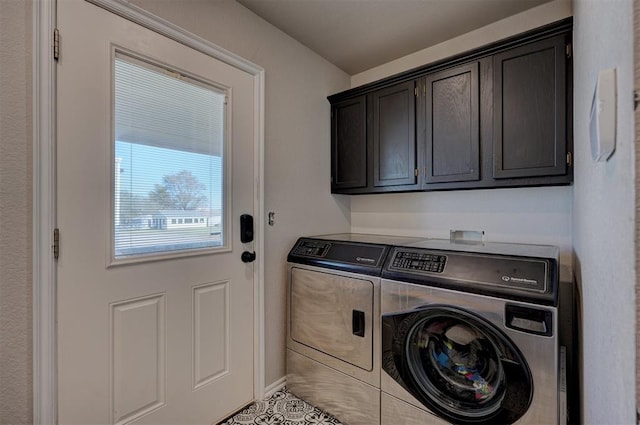 clothes washing area with cabinets, washing machine and dryer, and light tile patterned flooring