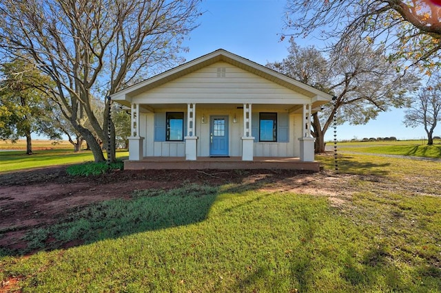 bungalow-style home featuring a porch and a front yard