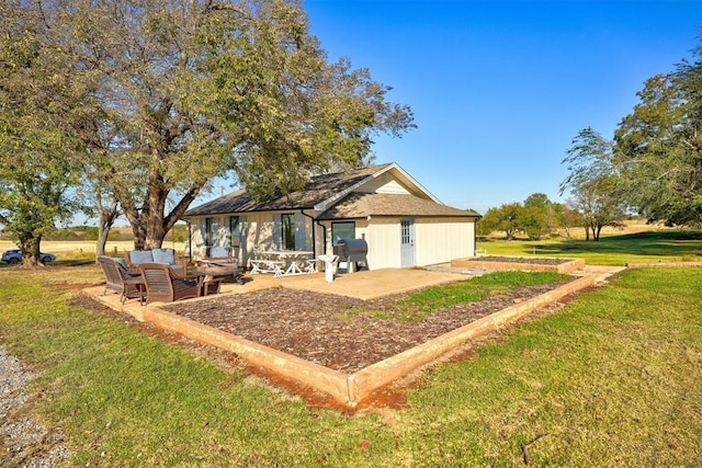 rear view of house featuring outdoor lounge area, a yard, and a patio