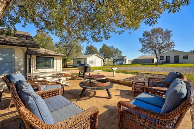 view of patio featuring a grill and an outdoor living space with a fire pit