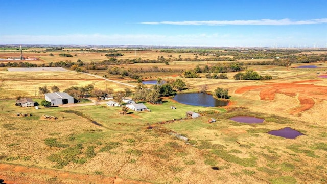 drone / aerial view with a water view and a rural view