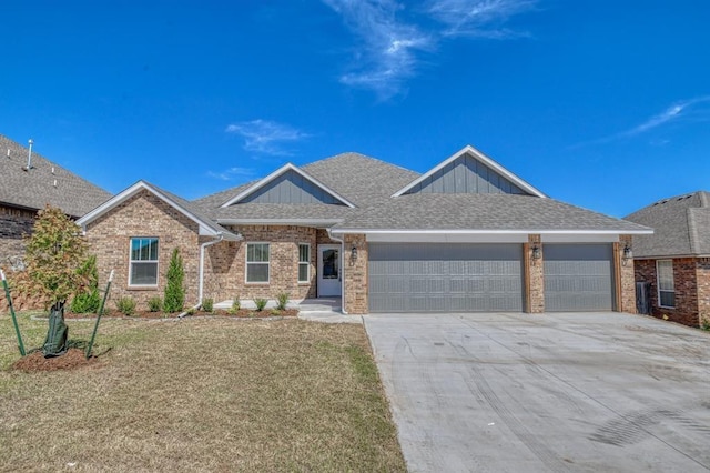 view of front of house featuring a garage and a front lawn