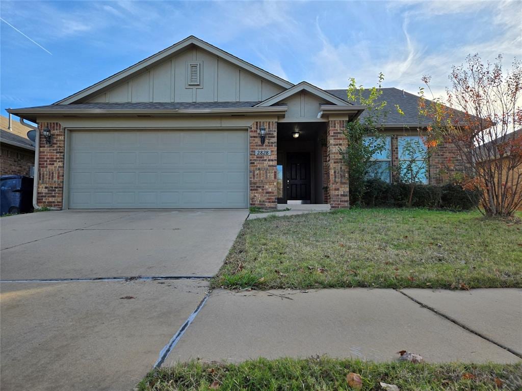 single story home featuring a garage and a front lawn