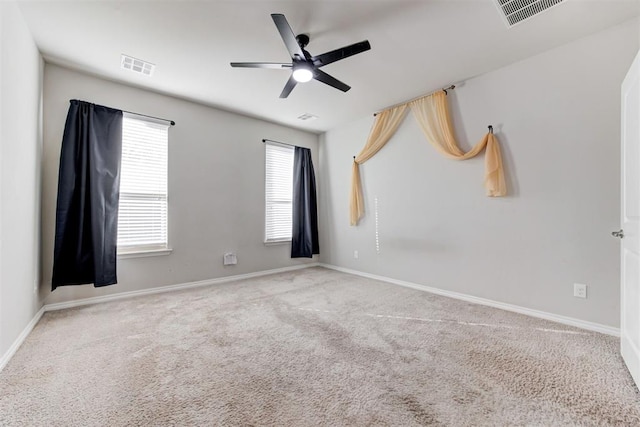 empty room with ceiling fan and carpet