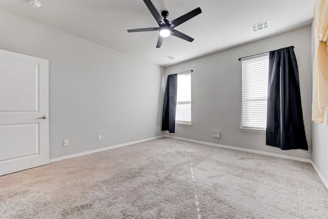 carpeted spare room featuring ceiling fan