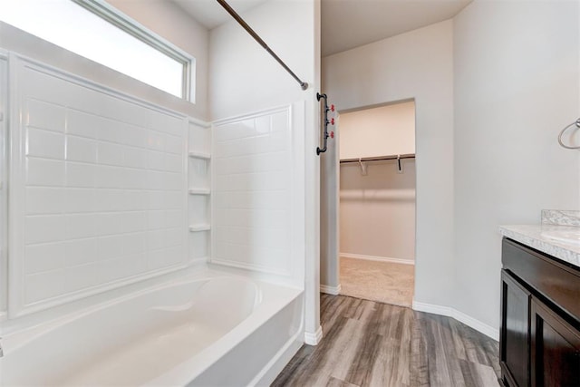 bathroom with bathing tub / shower combination, wood-type flooring, and vanity