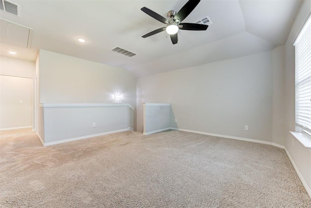 carpeted empty room with ceiling fan and lofted ceiling