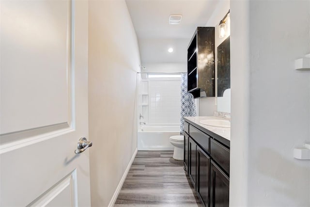 full bathroom featuring toilet, vanity,  shower combination, and hardwood / wood-style flooring