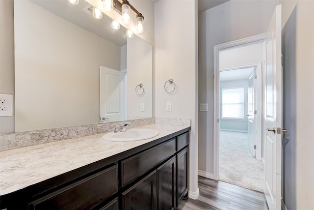 bathroom with hardwood / wood-style floors and vanity