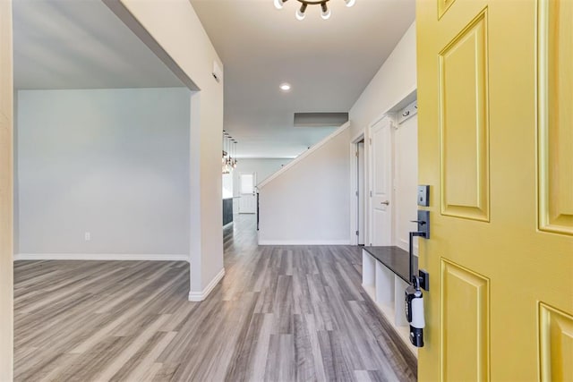 foyer entrance featuring an inviting chandelier and light wood-type flooring