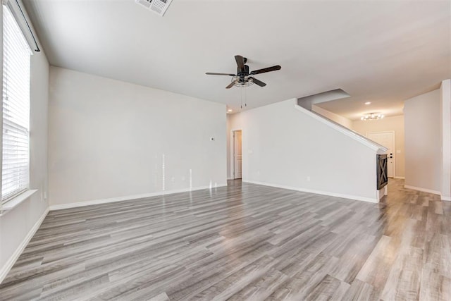 unfurnished living room featuring ceiling fan and light hardwood / wood-style flooring