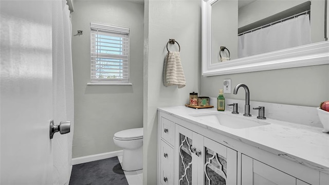 bathroom featuring vanity and toilet