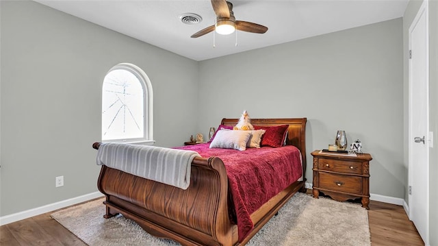 bedroom with light hardwood / wood-style floors and ceiling fan